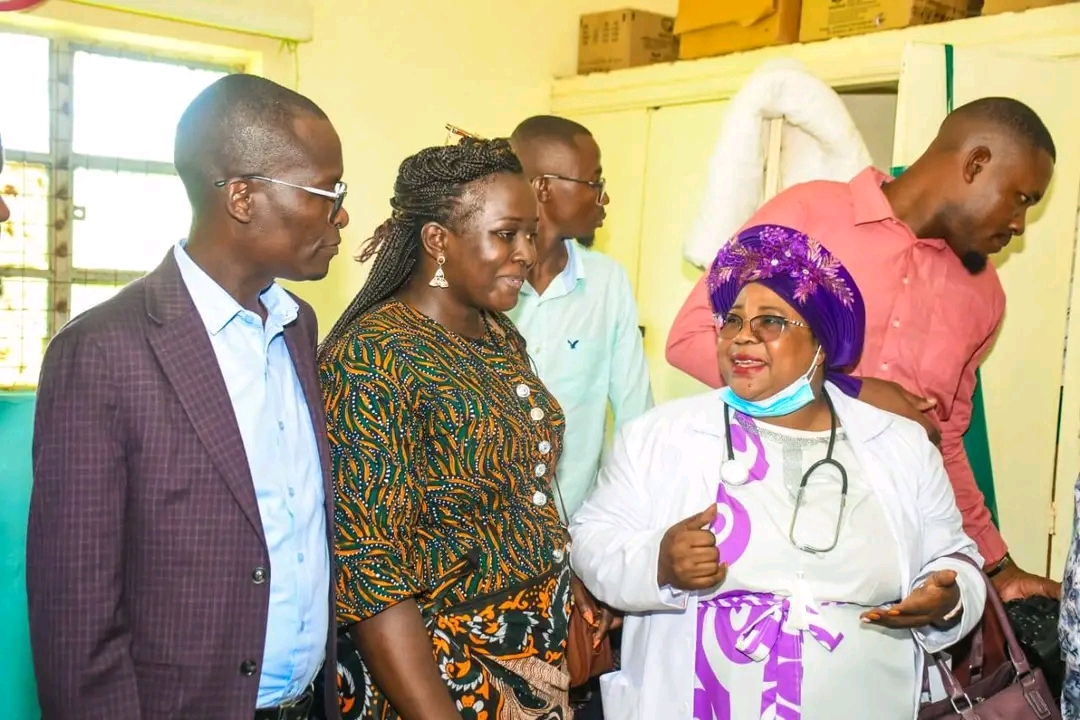 Dr Mildred Mudany, PhD briefs Hon. Moses Omondi on the medical camp activities at Ligega Health Centre.
